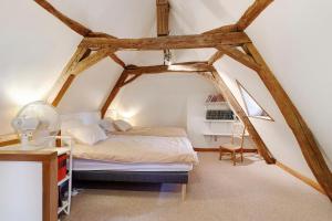 a bedroom with a bed in an attic at Maison Des Hôtes - Dordogne in Saint-Crépin-dʼAuberoche +27 photos