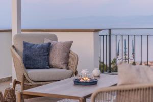 a living room with a chair and a coffee table at Villa Greta in Porto San Giorgio