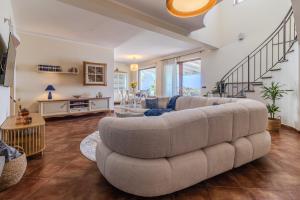 a living room with a large couch and a table at Villa Greta in Porto San Giorgio