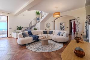 a living room with a white couch and a table at Villa Greta in Porto San Giorgio +66 photos