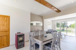 a kitchen and dining room with a table and a stove at Le saint remeau in Le Jard