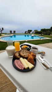 a plate of food on a table next to a pool at Garden Suite in Oya