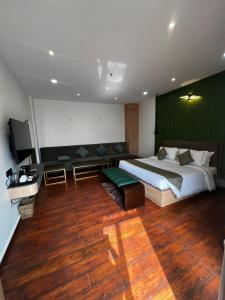 a bedroom with a large bed and a green wall at Nandan Inn in Dibrugarh