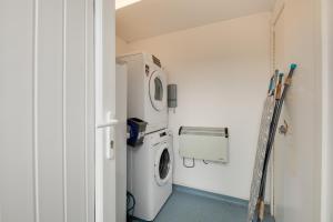 a laundry room with a washing machine in it at The Hides in Seahouses