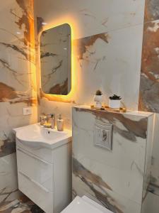 a white bathroom with a sink and a mirror at Vikanto Stay in Ulcinj +22 photos