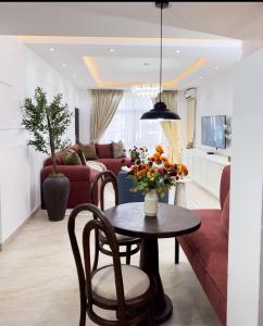 a living room with a table and a couch at Habitat Service Apartment in Ilado