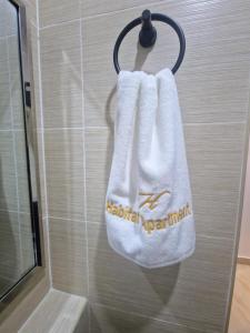 a towel hanging on a wall in a bathroom at Habitat Service Apartment in Ilado