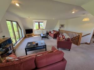 a living room with two couches and a table at Tylone in Lochdon