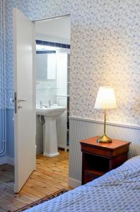 a bedroom with a sink and a table with a lamp at Château de Saint Clair in Saint-Clair-sur-lʼElle +46 photos