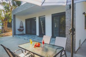 a table and chairs on a patio with an umbrella at Vikanto Stay in Ulcinj