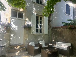 a group of chairs and tables in front of a building at Chambre d'hôtes - demeure historique in Chantenay-Saint-Imbert