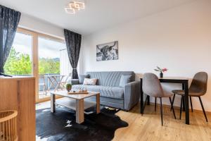 a living room with a couch and a table at FeWo Iller im Allgäu in Sonthofen