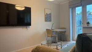 a living room with a flat screen tv on a wall at Jurmala Cozy Vibes - self check in in Jūrmala