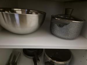 a shelf with a mixing bowl and other kitchen utensils at ZARA STUDIO BRASOV in Braşov +58 photos