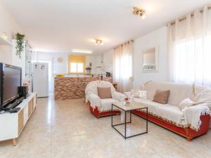 a living room with two couches and a tv at Holiday Home Panoramic by Interhome in Tordera
