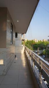 a building with a balcony with a view of a street at Utk 3 in Panchkula