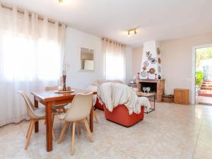 a living room with a dining room table and a fireplace at Holiday Home Panoramic by Interhome in Tordera +26 photos