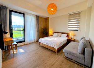 a bedroom with a bed and a couch and a window at 根本家民宿 in Dayi +18 photos