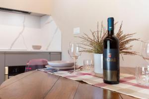 a bottle of wine sitting on a table with glasses at Il Poggiarello in Chianni +16 photos