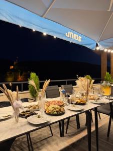 a table with plates of food on top of a roof at Hotel DIAMOND - სასტუმრო დაიმონდ in Akhaltsikhe