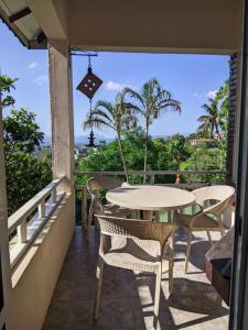 a patio with a table and chairs on a balcony at The Montfort - Kandy in Kandy