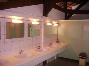 a bathroom with three sinks and three mirrors at Camping 3 étoiles - Piscine - ccbgbeh in Puy-lʼÉvêque