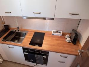 a small kitchen with a sink and a stove at ZARA STUDIO BRASOV in Braşov