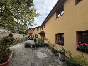 a courtyard of a building with potted plants at Penzión Sunflower in Piešťany