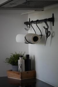 a pair of scissors and a roll of toilet paper on a wall at Filipponi's Träumli in Rüthi