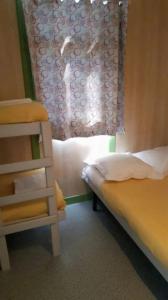a small bedroom with a bed and a window at Camping 3 étoiles - Piscine - ccbfihb in Casaglione +37 photos