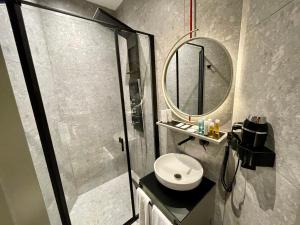 a bathroom with a shower and a toilet and a mirror at Nevv Bosphorus Hotel in Istanbul +27 photos