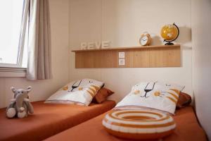 a bedroom with two twin beds with hello kitty pillows at Camping 2 étoiles - Piscine - ccbgb0d in Sospel