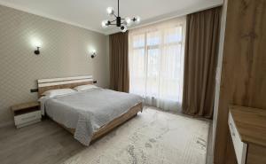 a bedroom with a bed and a large window at Коттедж в Азиа Палас in Chon-Sary-Oy +11 photos