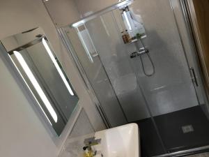 a bathroom with a shower and a sink at All Seasons B&B in Portrush
