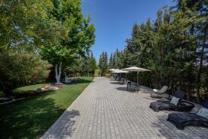 a walkway with chairs and umbrellas in a park at Manta Guest - Manta Rota Beach in Manta Rota