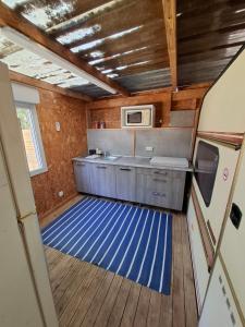 a kitchen with a blue floor in a room at Côté plage in Vias
