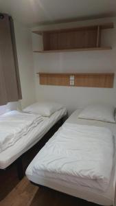 two beds in a room with white sheets at Camping 2 étoiles - Piscine - ccbfiif in Avignon +42 photos