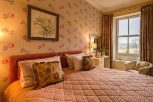 a bedroom with a large bed and a window at challan hall in Silverdale