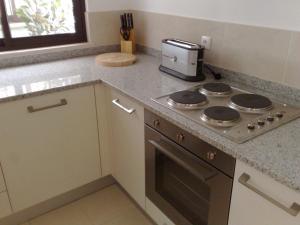 a kitchen with a stove and a coffee maker on a counter at Luxury 4 Bedroom Oceanfront Villa at 5 Star Tortuga Hotel, Santa Maria in Santa Maria