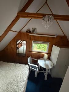 a room with a table and chairs in a attic at Dom z dużym tarasem nad jeziorem na wyłączność in Krasnopol +29 photos