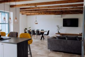 a living room with a couch and a table at Villa Francesca with Private Pool & Designer Interior in Kaštel