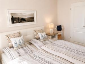 a bedroom with two beds and a picture on the wall at ZingstUrlauber in Zingst +31 photos