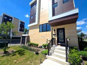 a house with a front door and stairs at Downsview Park Retreat 1 - Rogers Stadium Getaway in Toronto