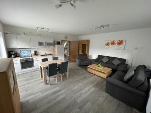 a living room with a couch and a table at Am Wangermeer 38a in Wangerland