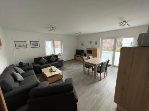 a living room with a couch and a table at Am Wangermeer 38a in Wangerland +4 photos