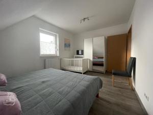 a bedroom with a bed and a desk and a window at Am Wangermeer 38a in Wangerland