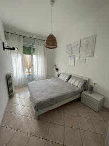 a bedroom with a large bed and a pendant light at Vista mare in San Vincenzo