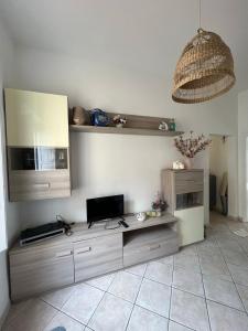 a living room with a table with a tv at Vista mare in San Vincenzo