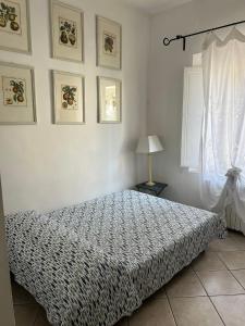 a bedroom with a bed and a window at Vista mare in San Vincenzo +6 photos