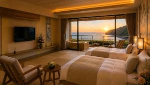 a hotel room with two beds and a view of the ocean at 카미소 in Tsushima